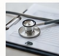A stethoscope resting on a clipboard